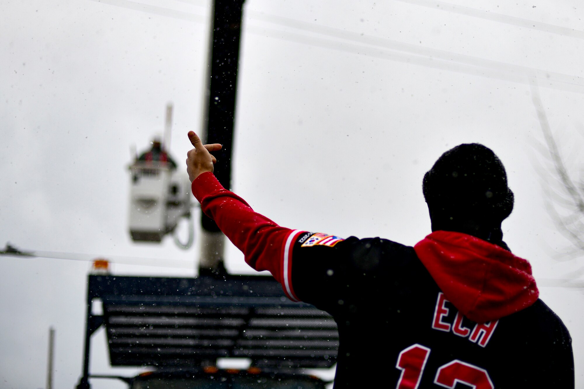 A technician marshals a bucket truck.