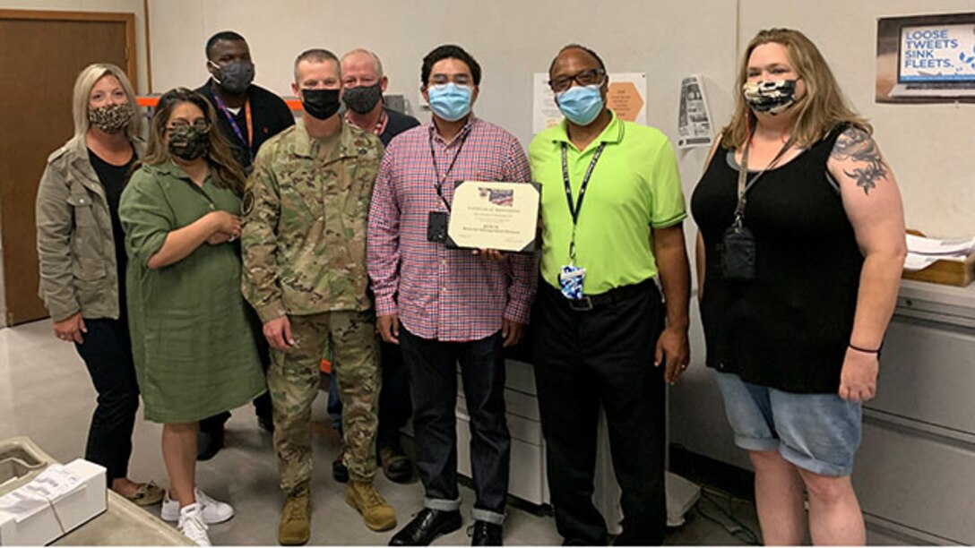 Air Force Col. Jason Kalin recognizes employees in the  MII  Shop Service Center Sept. 16, 2021.