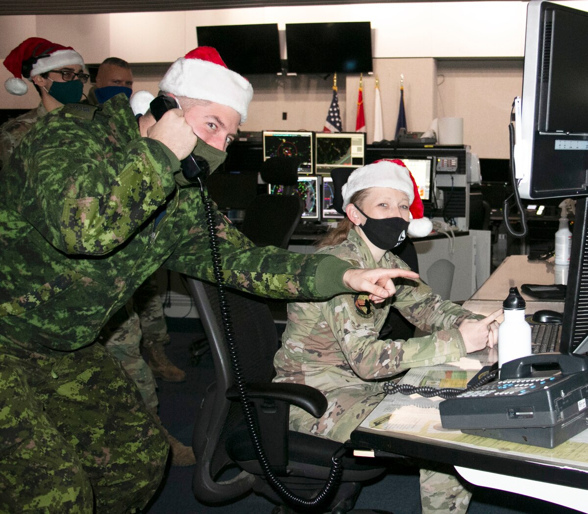 Capt. Kevin Vincent of the Royal Canadian Air Force, left, and Airman 1st Class Megan Mills of the New York Air National Guard’s 224th Air Defense Squadron, recently conducted training at the Eastern Air Defense Sector in Rome, N.Y., in preparation for NORAD Tracks Santa operations on Christmas Eve.