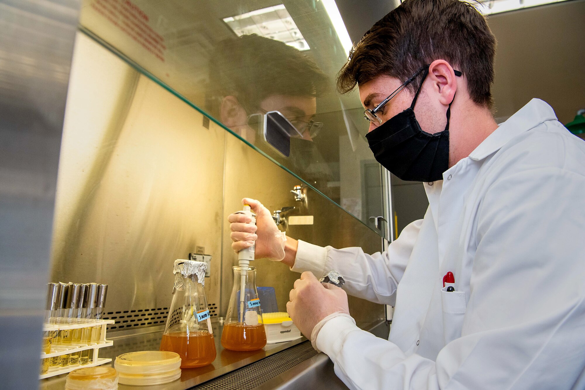 C1C David Hatfield inoculates overnight cultures of S. aureus (bacteria). Air Force Academy -- (U.S. Air Force photo/Trevor Cokley)