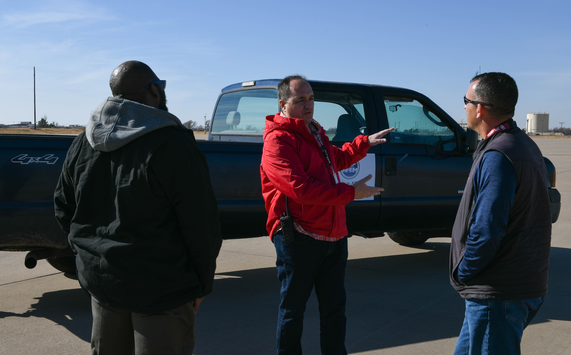 Anthony Bunch, 97th Operations Support Squadron airfield manager, discusses potential emergency sites with Keith Rodriguez, Federal Emergency Management Agency (FEMA) logistics section chief, and Samuel Hawkins, 97th Civil Engineer Squadron installation emergency manager, on Altus Air Force Base, Oklahoma, Dec. 16, 2021. In the case of a disaster hitting Southwest Oklahoma, FEMA could stage an operation on Altus AFB and be able to reach people seeking help within a two hour radius. (U.S. Air Force photo by Airman 1st Class Trenton Jancze)