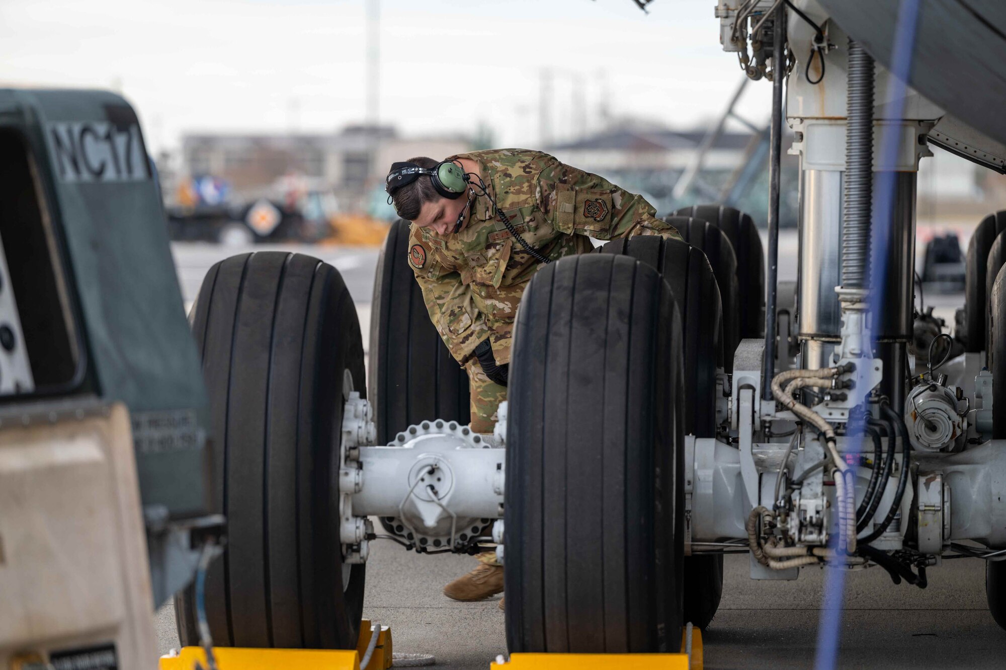 Staff Sgt. Caleb Osborne, 9th Airlift Squadron flight engineer, checks landing gear tires on a C-5M Super Galaxy before takeoff to Joint Base McGuire-Dix-Lakehurst, New Jersey, at Dover Air Force Base, Delaware, Dec. 17, 2021. The 9th AS delivered supplies to aid the Joint Base Pearl Harbor-Hickam (JBPHH), Hawaii water quality recovery, a joint U.S. military initiative working closely with the State of Hawaii, Department of Health, Honolulu Board of Water Supply, U.S. government and independent organizations to restore a safe water delivery system to JBPHH military housing communities through testing, treatment, and repair. For detailed information, including available resources and locations, and news, go to www.navy.mil/jointbasewater.      (U.S. Air Force photo by Senior Airman Faith Schaefer)
