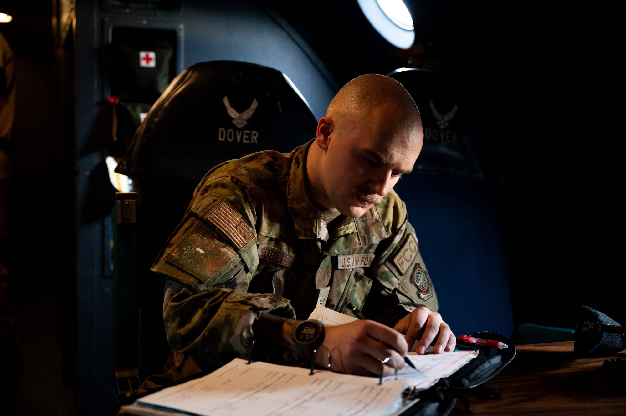 Senior Airman Bailey Doolittle, 436th Aircraft Maintenance Squadron flying crew chief, checks maintenance records on a C-5M Super Galaxy before takeoff at Dover Air Force Base, Delaware, Dec. 17, 2021. The 9th Airlift Squadron delivered supplies to aid the Joint Base Pearl Harbor-Hickam (JBPHH), Hawaii water quality recovery, a joint U.S. military initiative working closely with the State of Hawaii, Department of Health, Honolulu Board of Water Supply, U.S. government and independent organizations to restore a safe water delivery system to JBPHH military housing communities through testing, treatment, and repair. For detailed information, including available resources and locations, and news, go to www.navy.mil/jointbasewater. (U.S. Air Force photo by Senior Airman Faith Schaefer)