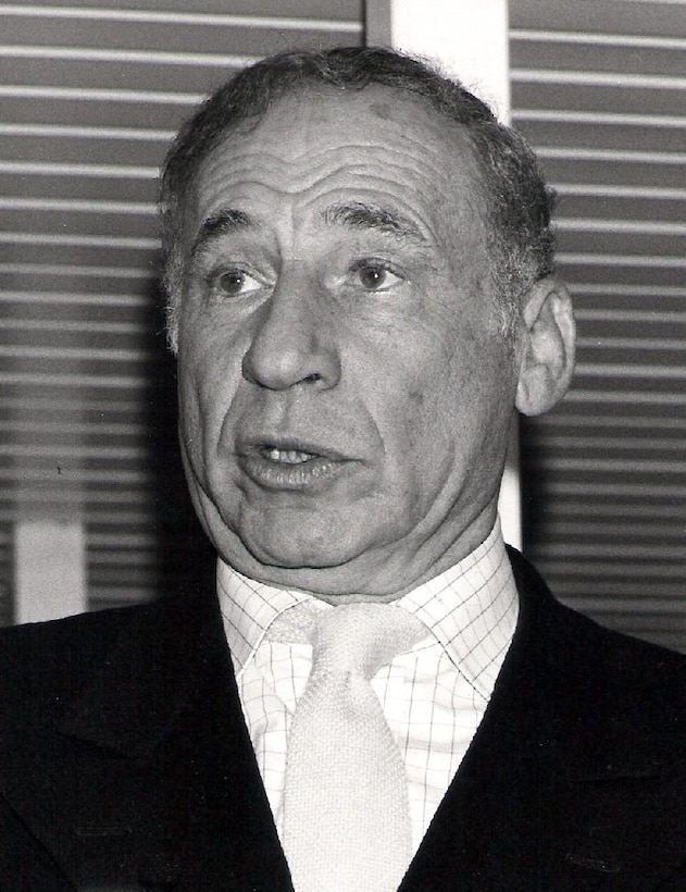 A man in a suit speaks.
