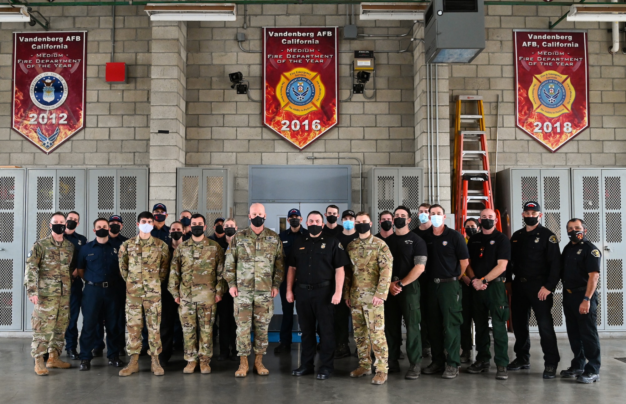 Chief of Space Operations Gen. John W. “Jay” Raymond and Chief Master Sergeant of the Space Force Roger A. Towberman, pose for a photo with members of the 30th Civil Engineer Squadron fire department at Vandenberg Space Force Base, Dec. 21, 2021. Raymond and Towberman visited VSFB as part of their “Thank you” tour this week. (U.S. Space Force photo by Airman 1st Class Rocio Romo)