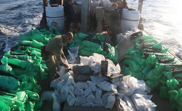 U.S. service members from patrol coastal ship USS Typhoon (PC 5) inventory an illicit shipment of weapons while aboard a stateless fishing vessel transiting international waters in the North Arabian Sea, Dec. 20, 2021.