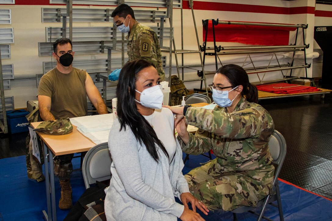 Two people get vaccinated.