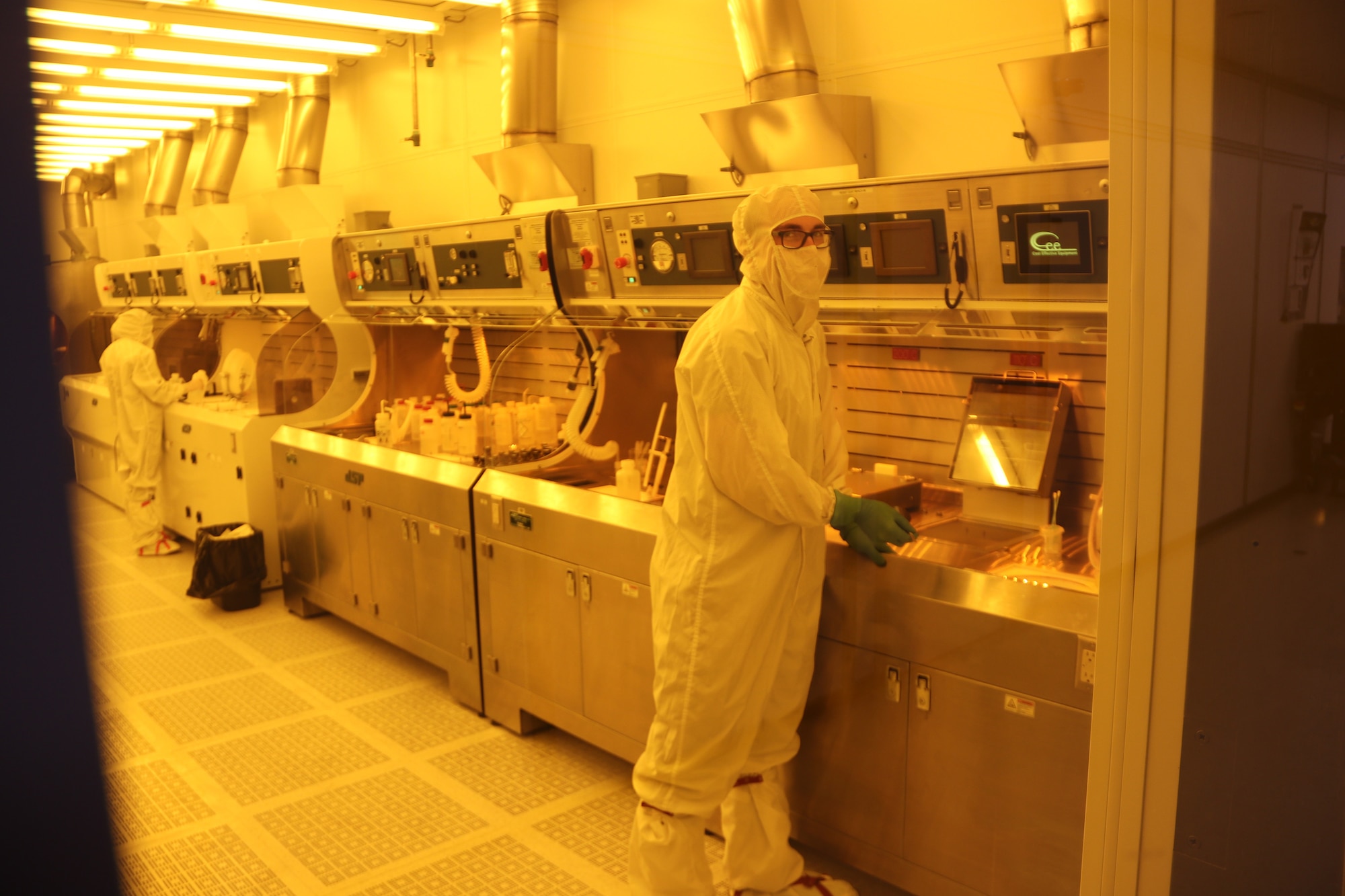 First Lt. Jeremiah Williams, front, works in the “clean room” of the Air Force Research Laboratory Sensors Directorate at Wright-Patterson Air Force Base near Dayton, Ohio. Lt. Williams is a recipient of an Air Force Edison Grant, which allows active duty researchers to lead short, highly-focused projects, with their own money. (U.S. Air Force photo/Michael Ross)