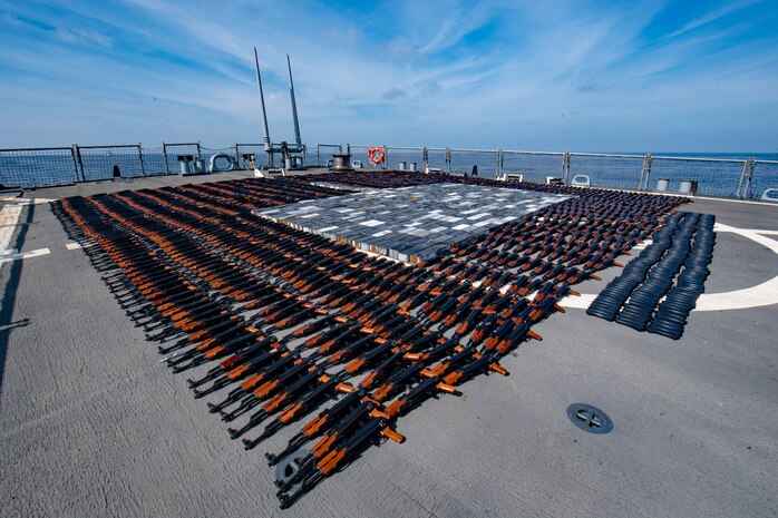 NORTH ARABIAN SEA - Illicit weapons seized from a stateless fishing vessel in the North Arabian Sea are arranged for inventory aboard guided-missile destroyer USS O’Kane’s (DDG 77) flight deck, Dec. 21, 2021.