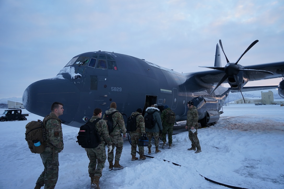 Members of the 176th Air Defense Squadron load onto an HC-130J Combat King II aircraft Dec. 2, 2021, at Joint Base Elmendorf-Richardson, Alaska, to help transport gifts to Bethel and Nome for further delivery to the villages of Chevak and Buckland, respectively, for Operation Santa Claus 2021. Op Santa is an Alaska National Guard annual community outreach program that provides gifts, books, school supplies and stocking stuffers to children in rural Alaskan communities. This year marks the 66th year of the program, which began in 1956 after the village of St. Mary's experienced a year of hardship and the Alaska Air National Guard flew in gifts and supplies donated by the local community. The Alaska National Guard was able to continue the tradition this year and safely provide gifts despite COVID-19. (U.S. Army National Guard photo by Dana Rosso/Released).