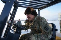 Alaska Army National Guard Sgt. Randell Andrew, an armory attendant in Bethel assigned to B Company, 1st Battalion, 297th Infantry Regiment, forklifts pallets of gifts from an HC-130J Combat King II aircraft Dec. 2, 2021, at Bethel, Alaska, before they are loaded onto an UH-60L Black Hawk helicopter for further delivery to Chevak as part of Operation Santa Claus 2021. Op Santa is an Alaska National Guard annual community outreach program that provides gifts, books, school supplies and stocking stuffers to children in rural Alaskan communities. This year marks the 66th year of the program, which began in 1956 after the village of St. Mary's experienced a year of hardship and the Alaska Air National Guard flew in gifts and supplies donated by the local community. The Alaska National Guard was able to continue the tradition this year and safely provide gifts despite COVID-19. (U.S. Army National Guard photo by Dana Rosso/Released).