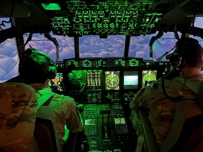 Capt. Trevor Bunkers, left, and Maj. Brandon Burns, right, both pilots assigned to 211th Rescue Squadron fly an HC-130J Combat King II aircraft en route to Joint Base Elmendorf-Richardson, Alaska from Nome, Dec. 2, 2021. Arctic Guardians of 176th Wing helped transport gifts to Bethel and Nome for further delivery to the villages of Chevak and Buckland, respectively, for Operation Santa Claus 2021. Op Santa is an Alaska National Guard annual community outreach program that provides gifts, books, school supplies and stocking stuffers to children in rural Alaskan communities. This year marks the 66th year of the program, which began in 1956 after the village of St. Mary's experienced a year of hardship and the Alaska Air National Guard flew in gifts and supplies donated by the local community. The Alaska National Guard was able to continue the tradition this year and safely provide gifts despite COVID-19. (U.S. Army National Guard photo by Dana Rosso/Released).