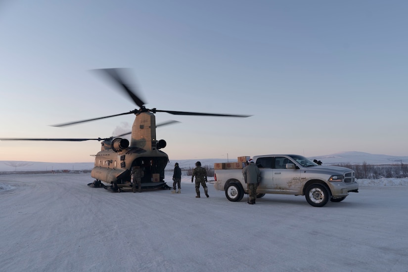 Gifts are unloaded from a CH-47 Chinook helicopter in Buckland, Alaska during Operation Santa Claus, Dec. 14, 2021. Operation Santa Claus is an Alaska National Guard annual community outreach program that provides Christmas gifts, books, school supplies and stocking stuffers to children in rural Alaskan communities. This year marks the 66th year of the program, which began in 1956 after the village of St. Mary's experienced a year of hardship and the Alaska Air National Guard flew in gifts and supplies donated by the local community. The Alaska National Guard was able to continue the tradition this year and safely provide gifts despite COVID-19. (U.S. Air National Guard photo by Maj. Chelsea Aspelund)