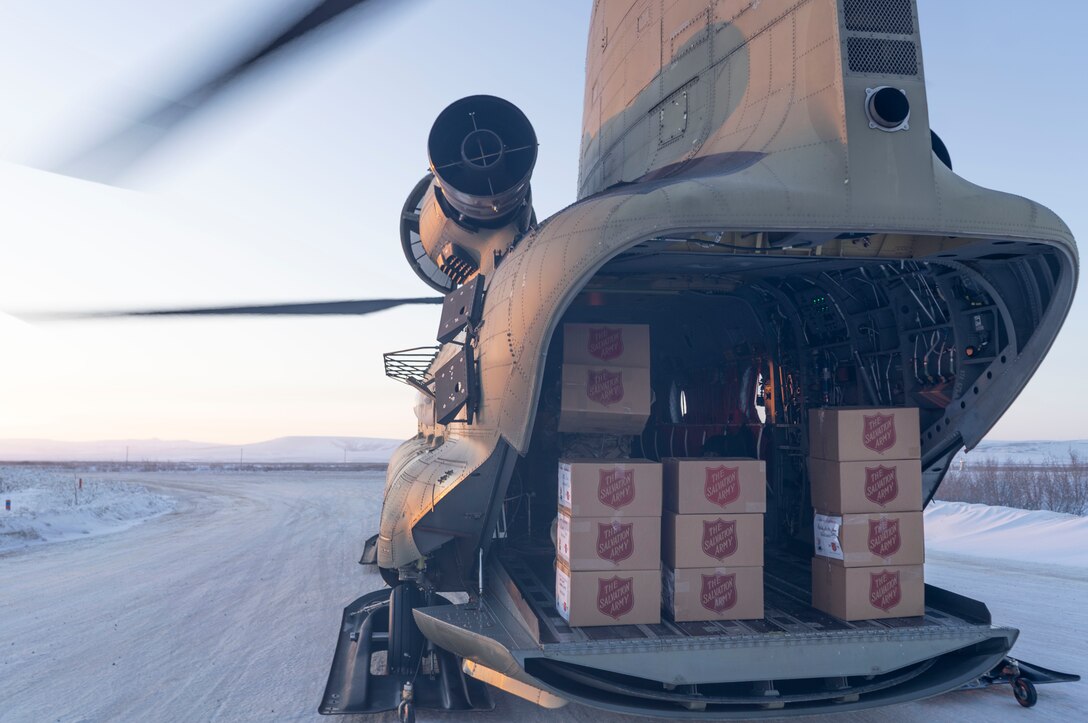 Two hundred sixety-one gift packages are unloaded from a CH-47 Chinook helicopter in Buckland, Alaska during Operation Santa Claus, Dec. 14, 2021. Operation Santa Claus is an Alaska National Guard annual community outreach program that provides Christmas gifts, books, school supplies and stocking stuffers to children in rural Alaskan communities. This year marks the 66th year of the program, which began in 1956 after the village of St. Mary's experienced a year of hardship and the Alaska Air National Guard flew in gifts and supplies donated by the local community. The Alaska National Guard was able to continue the tradition this year and safely provide gifts despite COVID-19. (U.S. Air National Guard photo by Maj. Chelsea Aspelund)