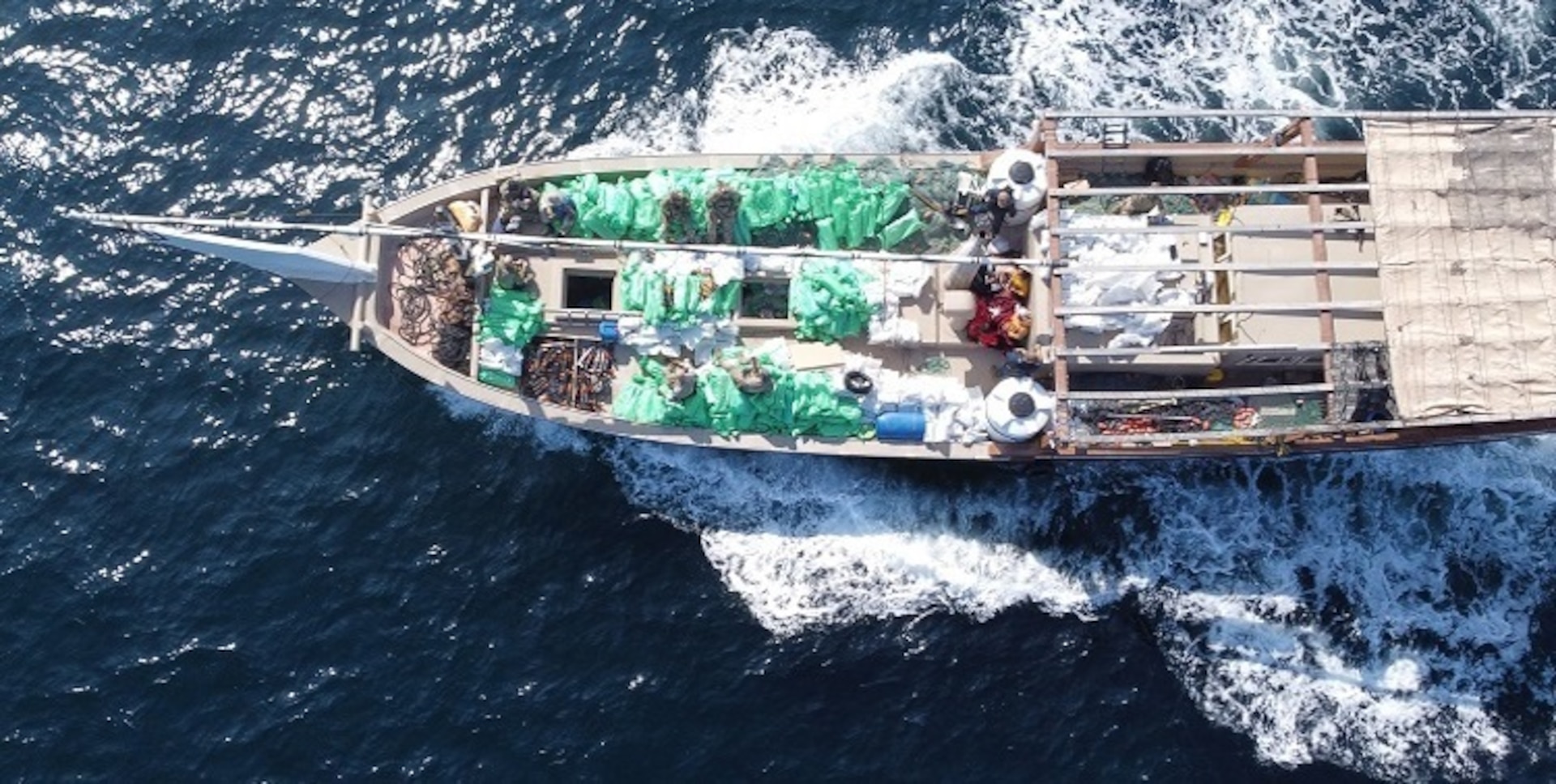 NORTH ARABIAN SEA - U.S. service members from patrol coastal ship USS Typhoon (PC 5) inventory an illicit shipment of weapons while aboard a stateless fishing vessel transiting international waters in the North Arabian Sea, Dec. 20, 2021.