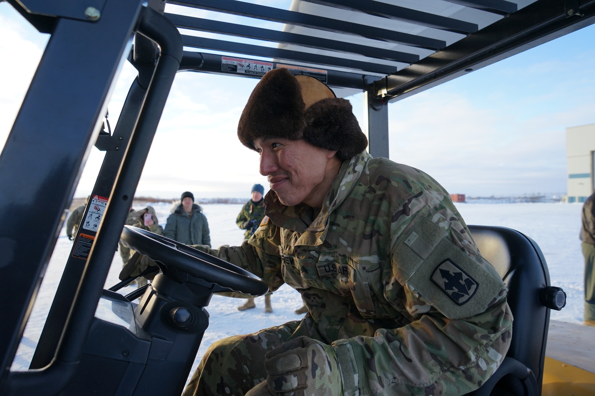 Alaska Army National Guard Sgt. Randell Andrew, an armory attendant in Bethel assigned to B Company, 1st Battalion, 297th Infantry Regiment, forklifts pallets of gifts from an HC-130J Combat King II aircraft Dec. 2, 2021, at Bethel, Alaska, before they are loaded onto an UH-60L Black Hawk helicopter for further delivery to Chevak as part of Operation Santa Claus 2021. Op Santa is an Alaska National Guard annual community outreach program that provides gifts, books, school supplies and stocking stuffers to children in rural Alaskan communities. This year marks the 66th year of the program, which began in 1956 after the village of St. Mary's experienced a year of hardship and the Alaska Air National Guard flew in gifts and supplies donated by the local community. The Alaska National Guard was able to continue the tradition this year and safely provide gifts despite COVID-19. (U.S. Army National Guard photo by Dana Rosso/Released).