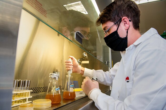 Cadet 1st Class David Hatfield inoculates overnight cultures of S. aureus (bacteria). Hatfield and other U.S. Air Force cadets are using Edison Grants to further their research. The Edison Grant is an initiative to increase the technical proficiency of Airmen and Guardians by funding highly-focused, military-led, research through small, short, and rigorous experiments in a risk-tolerant environment. (U.S. Air Force photo by Trevor Cokley)