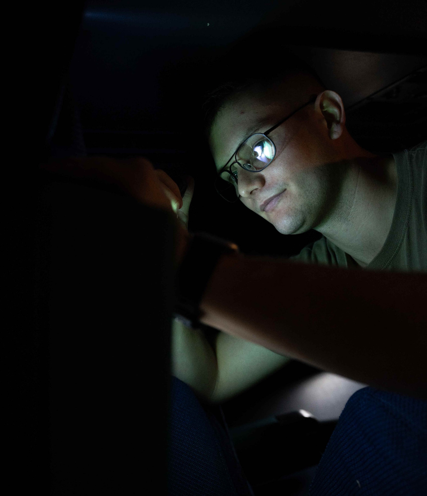 Senior Airman Kristopher Kelly, 9th Airlift Squadron loadmaster, performs a pre-flight check in the crew deck of a C-5M Super Galaxy at Dover Air Force Base, Delaware, Dec. 17, 2021. The 9th AS delivered supplies to aid the Joint Base Pearl Harbor-Hickam (JBPHH), Hawaii water quality recovery, a joint U.S. military initiative working closely with the State of Hawaii, Department of Health, Honolulu Board of Water Supply, U.S. government and independent organizations to restore a safe water delivery system to JBPHH military housing communities through testing, treatment, and repair. For detailed information, including available resources and locations, and news, go to www.navy.mil/jointbasewater. (U.S. Air Force photo by Senior Airman Faith Schaefer)