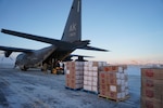 Members of the 176th Wing, Alaska Air National Guard, unload pallets of gifts from an HC-130J Combat King II aircraft Dec. 2, 2021, at Nome, Alaska, before they are loaded onto an CH-47 Chinook helicopter for delivery to Buckland as part of Operation Santa Claus 2021. This year marks the 66th year of the program.