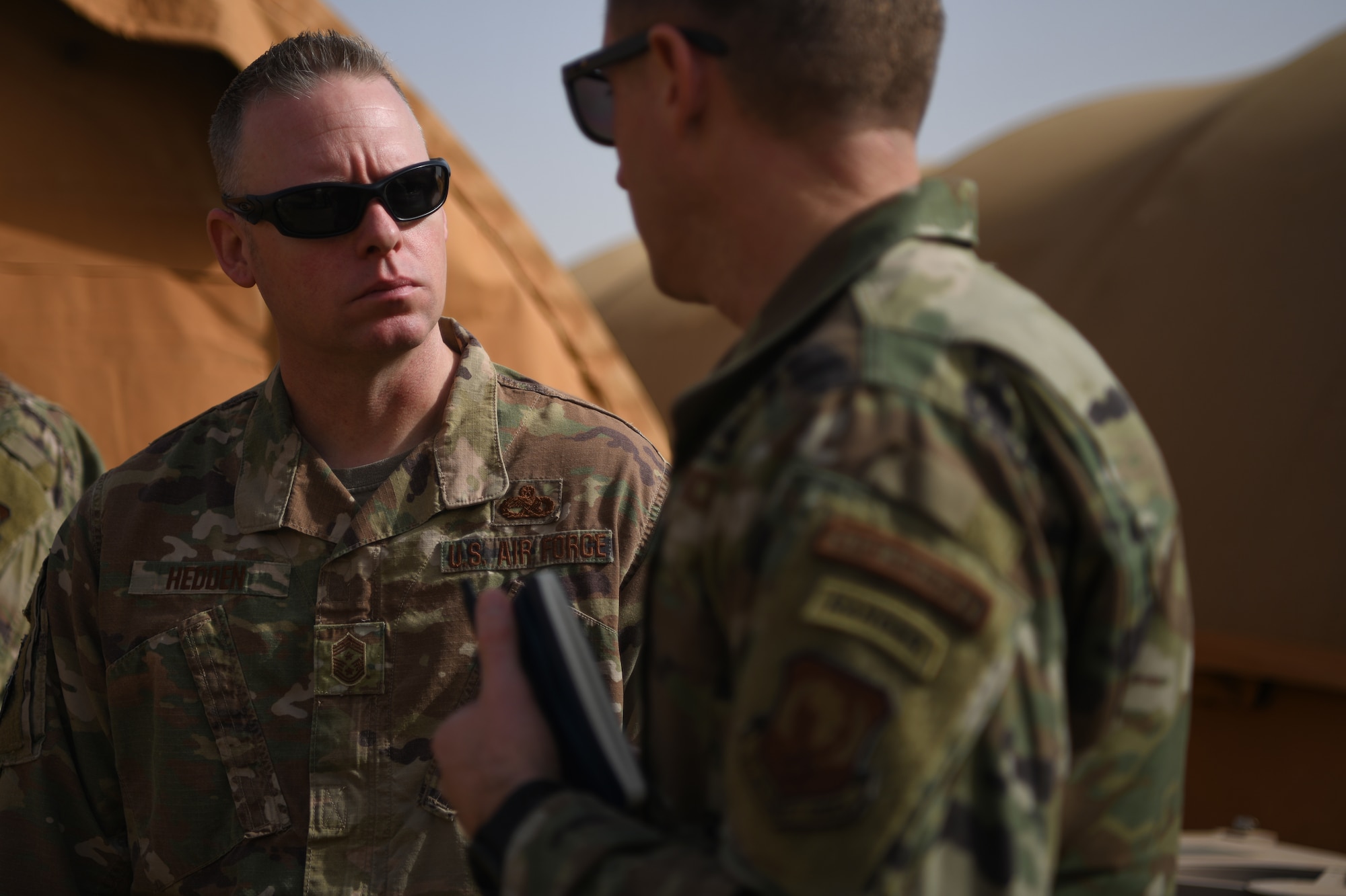 Chief Master Sgt. Benjamin W. Hedden, U.S. Air Forces in Europe and U.S. Air Forces Africa command chief, left, talks to Chief Master Sgt. Corey Crow, 435th Air Ground Operations Wing and 435th Air Expeditionary Wing command chief, at Nigerien Air Base 101, Niamey, Dec. 22, 202. Members from agency headquarters often conduct site visits to downrange personnel to measure team preparedness, capabilities, and receive ground level situational awareness. (U.S. Air Force photo by Senior Airman Ericka A. Woolever)