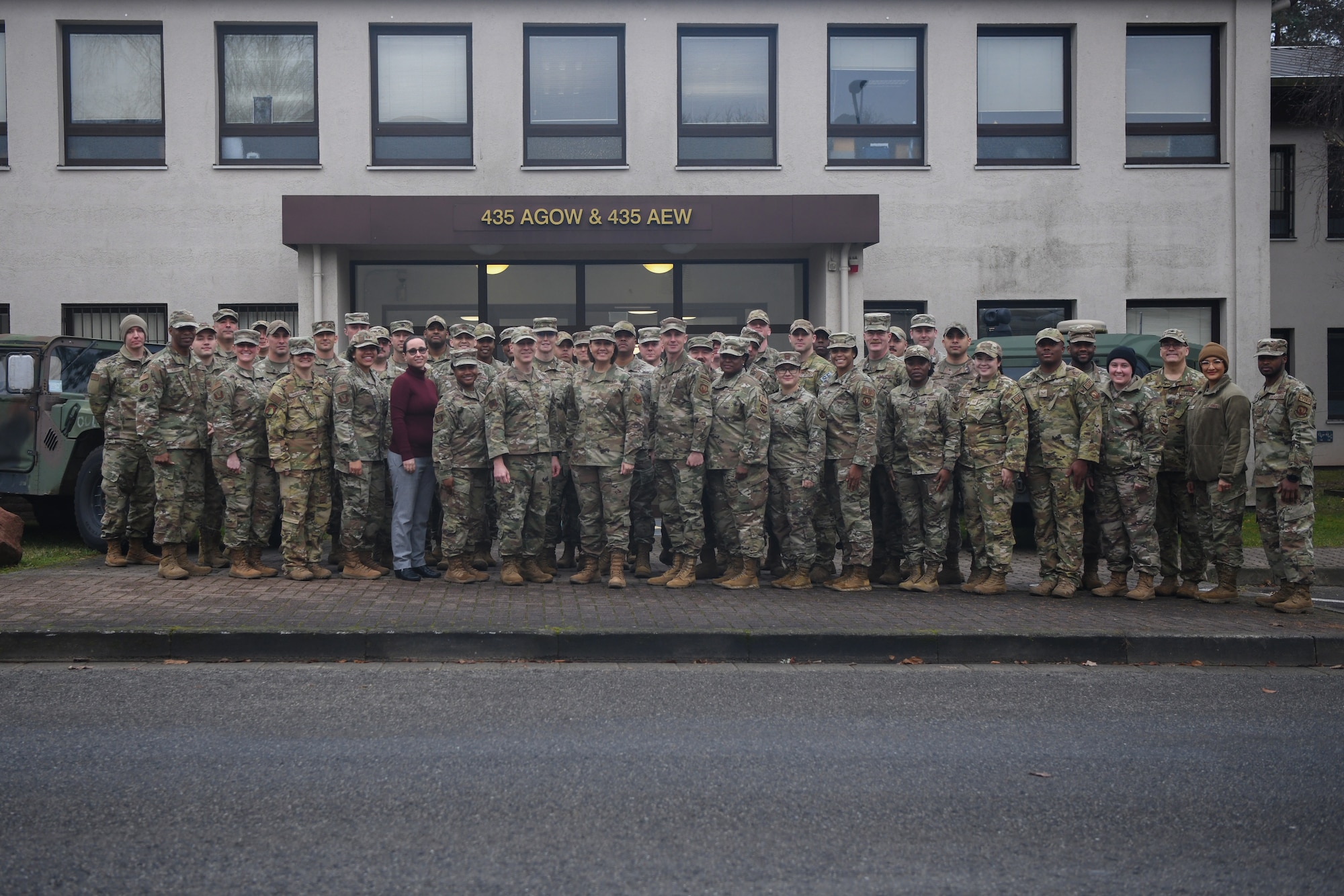 Chief Master Sgt. of the Air Force JoAnne S. Bass and Airmen from the 435th Air Expeditionary Wing (AEW) pose for a group photo at Ramstein Air Base, Germany, Dec. 19, 2021. The 435th AEW is the first and only air wing in Africa which provides secure, reliable, flexible expeditionary air power for combatant commanders. (U.S. Air Force photo by Senior Airman Ericka A. Woolever)