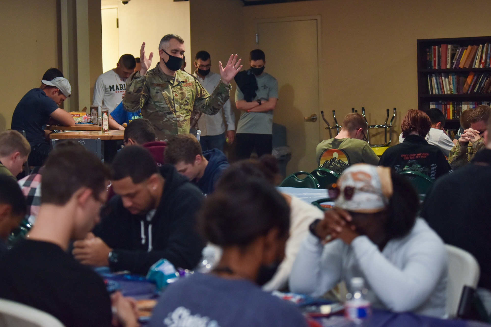 U.S. Air Force Lt. Col. Jeremiah Blackburn, 17th Training Wing chaplain delivers opening remarks and a prayer for students during the Exodus dinner at the Crossroads on Goodfellow Air Force Base, Dec. 22, 2021. The event was planned and executed by the Chapel staff along with local church partner, Sierra Vista. (U.S. Air Force photo by Staff Sgt.  Jermaine Ayers)