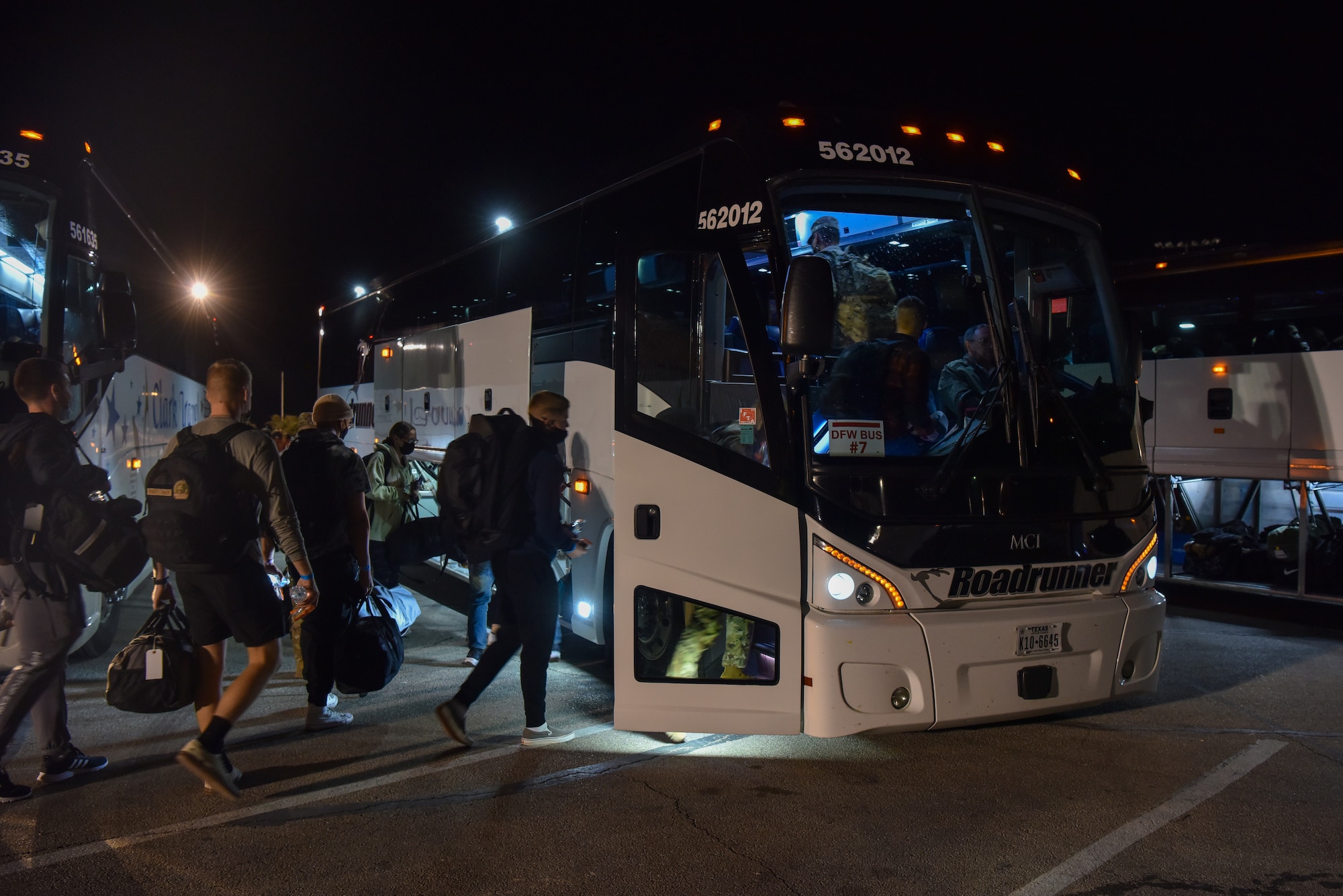 Goodfellow students board buses during Exodus at the Mathis Fitness Center on Goodfellow Air Force Base, Texas, Dec. 22, 2021.  About 900 students participated in Exodus for the holiday season. (U.S. Air Force photo by Staff Sgt. Jermaine Ayers)