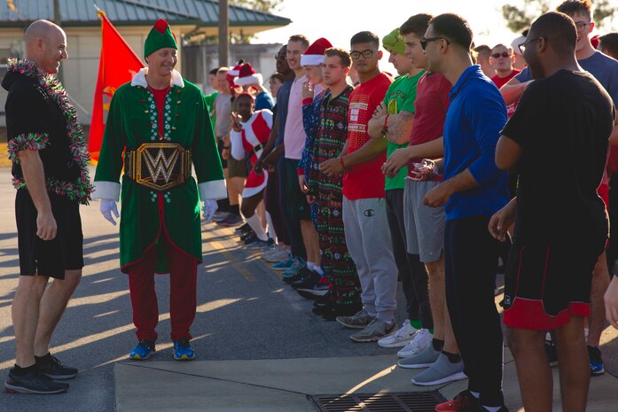 U.S. Marine Corps Col. Curtis V. Ebitz, left, commanding officer of Marine Corps Air Station New River, speaks with Marines before a unit holiday run, on MCAS New River in Jacksonville, North Carolina, Dec. 17, 2021. The run was held to strengthen camaraderie, improve unit cohesion, and celebrate the holidays.