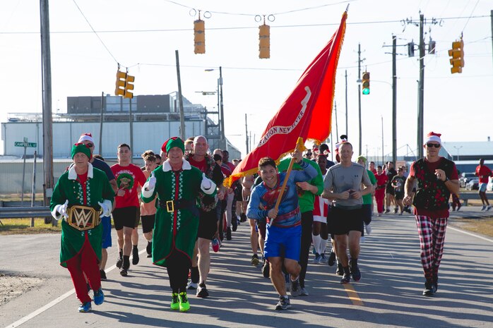 U.S. Marines with Marine Corps Air Station New River participate in a unit holiday run, on MCAS New River in Jacksonville, North Carolina, Dec. 17, 2021. The run was held to strengthen camaraderie, improve unit cohesion, and celebrate the holidays.