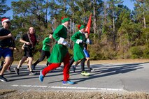 U.S. Marines with Marine Corps Air Station New River participate in a unit holiday run, on MCAS New River, Jacksonville, North Carolina, Dec. 17, 2021. The run was held to strengthen camaraderie, improve unit cohesion, and celebrate the holidays.