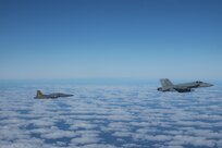 A Tunisian F-5E Tiger II and an F/A-18E Super Hornet, attached to the “Fighting Checkmates” of Strike Fighter Squadron (VFA) 211, train together in simulated air defense exercises, Dec. 20, 2021.