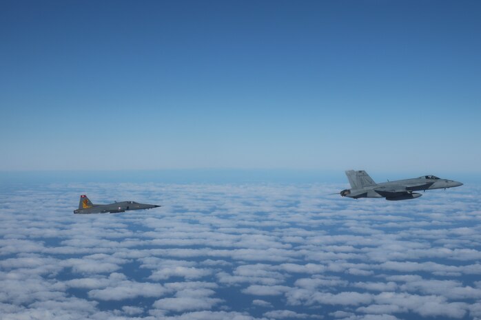 A Tunisian F-5E Tiger II and an F/A-18E Super Hornet, attached to the “Fighting Checkmates” of Strike Fighter Squadron (VFA) 211, train together in simulated air defense exercises, Dec. 20, 2021.