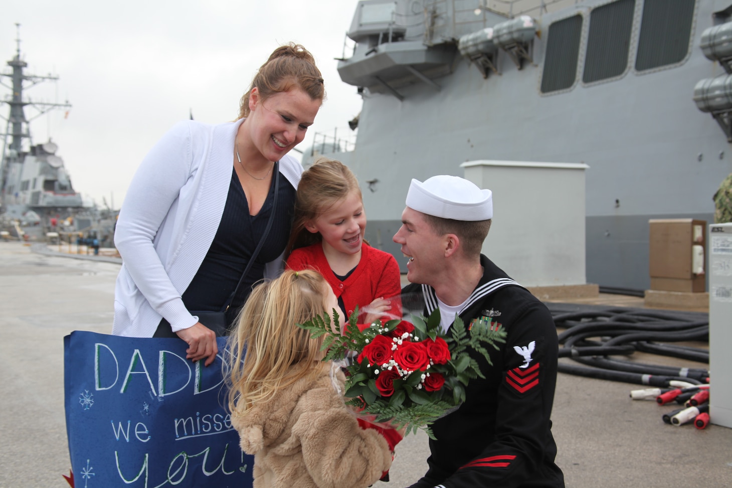 Gas Turbine System Technician First Class Kristofer Black is greeted by family after the Arleigh Burke-class guided missile destroyer USS Arleigh Burke (DDG 51) returned to Rota, Spain, Dec. 23, 2021, completing her inaugural patrol as a member of the U.S. Navy’s Forward Deployed Naval Forces-Europe (FDNF-E). Arleigh Burke, forward-deployed to Rota, Spain, is on its first patrol in the U.S. Sixth Fleet area of operations in support of U.S. National Security Interests and regional allies and partners.