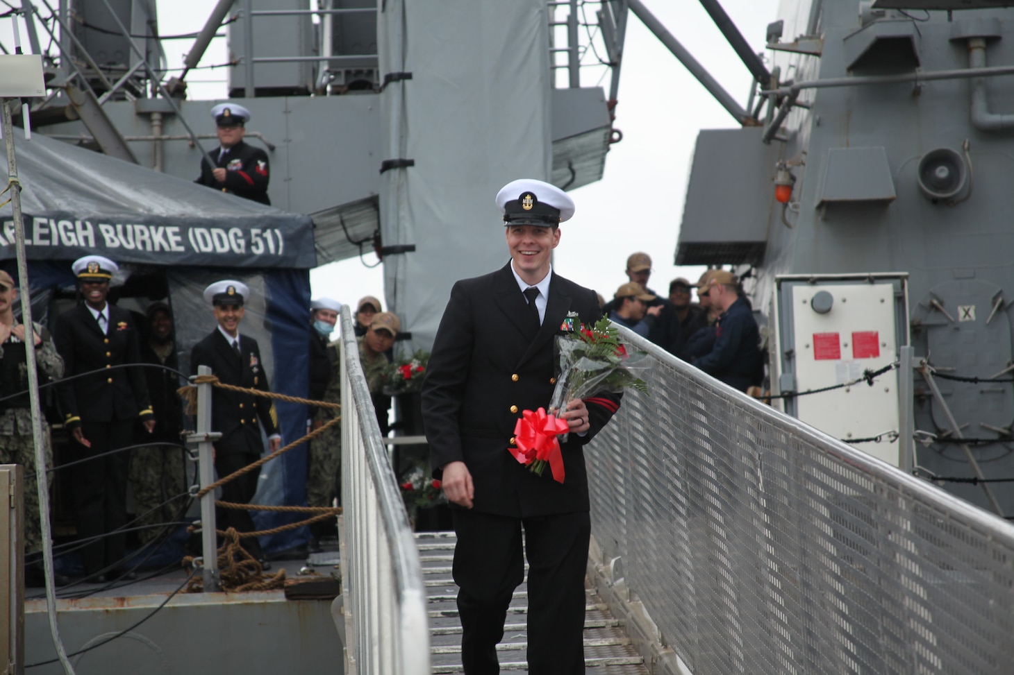Chief Intelligence Specialist John Quinlan is first off the ship as he is greeted by family after the Arleigh Burke-class guided missile destroyer USS Arleigh Burke (DDG 51) returned to Rota, Spain, Dec. 23, 2021, completing her inaugural patrol as a member of the U.S. Navy’s Forward Deployed Naval Forces-Europe (FDNF-E). Arleigh Burke, forward-deployed to Rota, Spain, is on its first patrol in the U.S. Sixth Fleet area of operations in support of U.S. National Security Interests and regional allies and partners.
