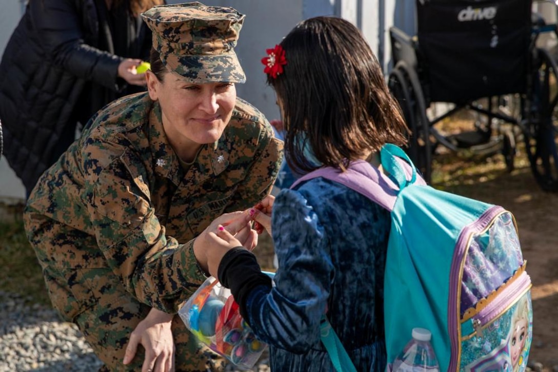 U.S. Marine Lt. Col. Quinci Martin, Task Force Operations Officer, gives her rank to an Afghan guest before they depart from Upshur Village on Marine Corps Base Quantico, VA, Dec. 22, 2021. The Department of Defense, through U.S. Northern Command, and in support of the Department of Homeland Security, is providing transportation, temporary housing, medical screening, and general support for at least 50,000 Afghan evacuees at suitable facilities, in permanent or temporary structures, as quickly as possible. This initiative provides Afghan personnel essential support at secure locations outside Afghanistan.