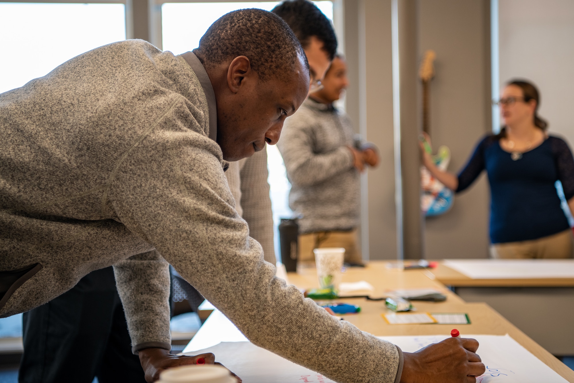 Major Kenneth Hawkins, 22nd Contracting Squadron commander, writes his personality type’s strengths and values on a sheet of paper as part of a Four Lenses training event Dec. 23, 2021, at the Greater Wichita Partnership in downtown Wichita, Kansas.