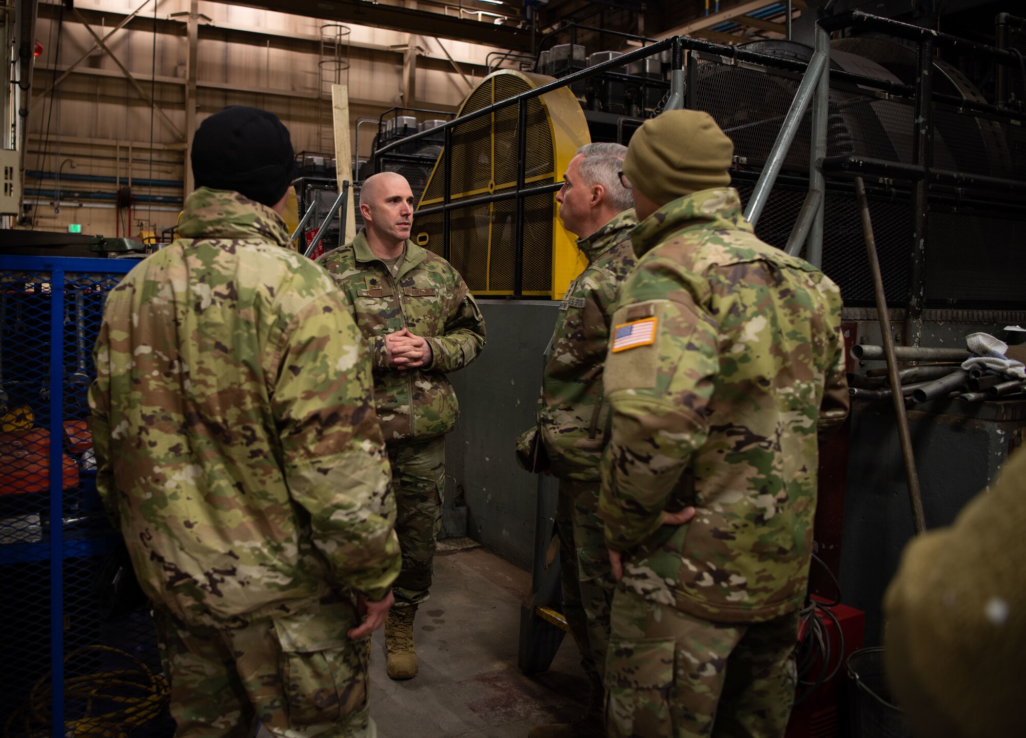 Lt. Col. David Brost, 821st Support Squadron commander, briefs Lt. Gen. Stephen N. Whiting, Space Operations Command commander, Chief Master Sgt. John Bentivegna, SpOC senior enlisted leader, and Col. Brian Kehl, SpOC Deputy to the Commanding General for Support, at one of the power plants during their visit to Thule Air Base, Greenland, Dec. 16, 2021. Gen. Whiting and the SpOC command team traveled to Thule to meet with Airmen and Guardians from the 821st Air Base Group, 23rd Space Operations Squadron and 12th Space Warning Squadron to gain a better understanding of their current challenges and successes. Thule is one of the most austere environments the Department of Defense operates from, and all operations at are powered and fueled internally which makes the base’s power infrastructure a key area of interest. (U.S. Space Force photo by Master Sgt. Sara Keller)