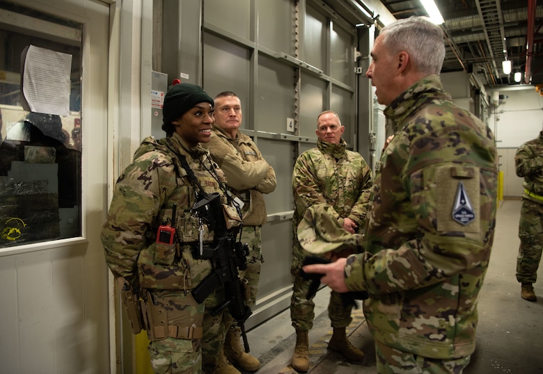 Lt. Gen. Stephen N. Whiting, Space Operations Command commander, speaks with Airman 1st Class Avyon Pearson, 821st Security Forces Squadron, after recognizing her for superior performance while at Thule Air Base, Greenland, Dec. 17, 2021. Gen. Whiting and the SpOC command team traveled to Thule to meet with Airmen and Guardians from the 821st Air Base Group and the 12th Space Warning Squadron to gain a better understanding of their current challenges and successes. Thule is one of the most austere environments the Department of Defense operates from and all operations are powered and fueled internally, with the nearest populated village being over 70 miles away. Thule is the DoD’s northern most installation located 750 miles north of the Arctic Circle and only 947 miles south of the North Pole. (U.S. Space Force photo by Master Sgt. Sara Keller)