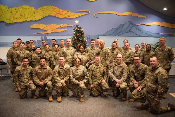 Lt. Gen. Stephen N. Whiting, Space Operations Command commander, Chief Master Sgt. John Bentivegna, SpOC senior enlisted leader, and Airmen, Guardians, and coalition partners from the 821st Air Base Group, 23rd Space Operations Squadron and the 12th Space Warning Squadron take a group photo at the dining facility during a visit from the SpOC command team’s visit to Thule Air Base, Greenland, Dec. 16 and 17, 2021. Gen. Whiting and the SpOC command team traveled to Thule to visit various locations throughout the base to better understand the current challenges Airmen and Guardians are facing in terms of mission and quality of life. Thule is the Department of Defense’s northernmost installation located 750 miles north of the Arctic Circle and only 947 miles south of the North Pole which brings significant challenges such as significant internet degradation, seasonal depression issues, and more. (U.S. Space Force photo by Master Sgt. Sara Keller)