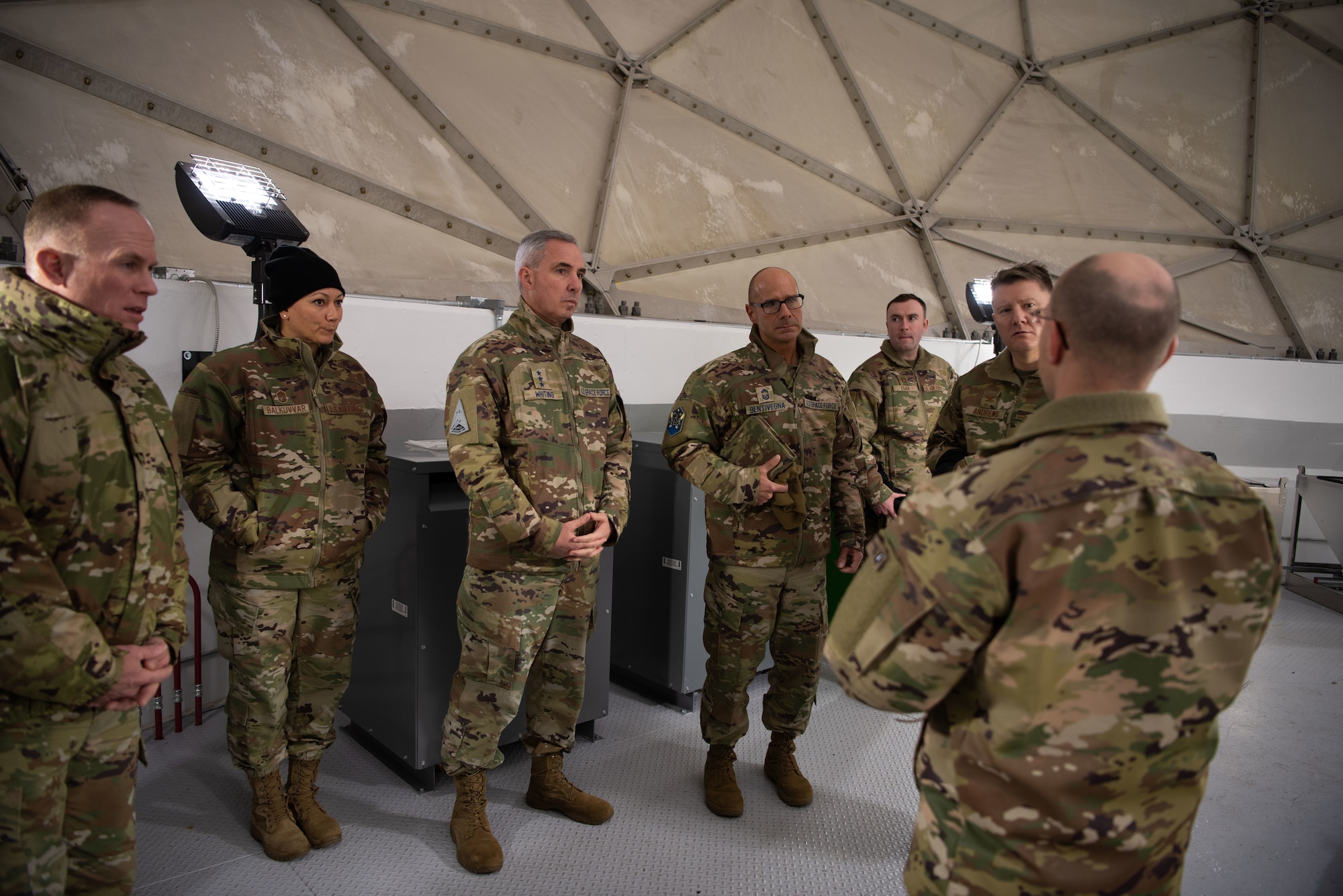 Master Sgt. John Eckert, detachment chief for the 23rd Space Operations Squadron Detachment 1, briefs Lt. Gen. Stephen N. Whiting, Space Operations Command commander, and Chief Master Sgt. John Bentivegna, SpOC senior enlisted leader, during their visit to Thule Air Base, Greenland, Dec. 17, 2021. Gen. Whiting and the SpOC command team traveled to Thule to meet with Airmen and Guardians from the 821st Air Base Group, 23 SOPS, and the 12th Space Warning Squadron to gain a better understanding of their current challenges and successes as Department of Defense’s northernmost installation located 750 miles north of the Arctic Circle and only 947 miles south of the North Pole. Other areas discussed throughout the visit included initiatives to improve Thule’s Air Force Research Laboratory, Low-Earth Orbit, Starlink terminals, Communications Satellite upgrades, and support for U.S. Northern Command events in the Arctic. (U.S. Space Force photo by Master Sgt. Sara Keller)