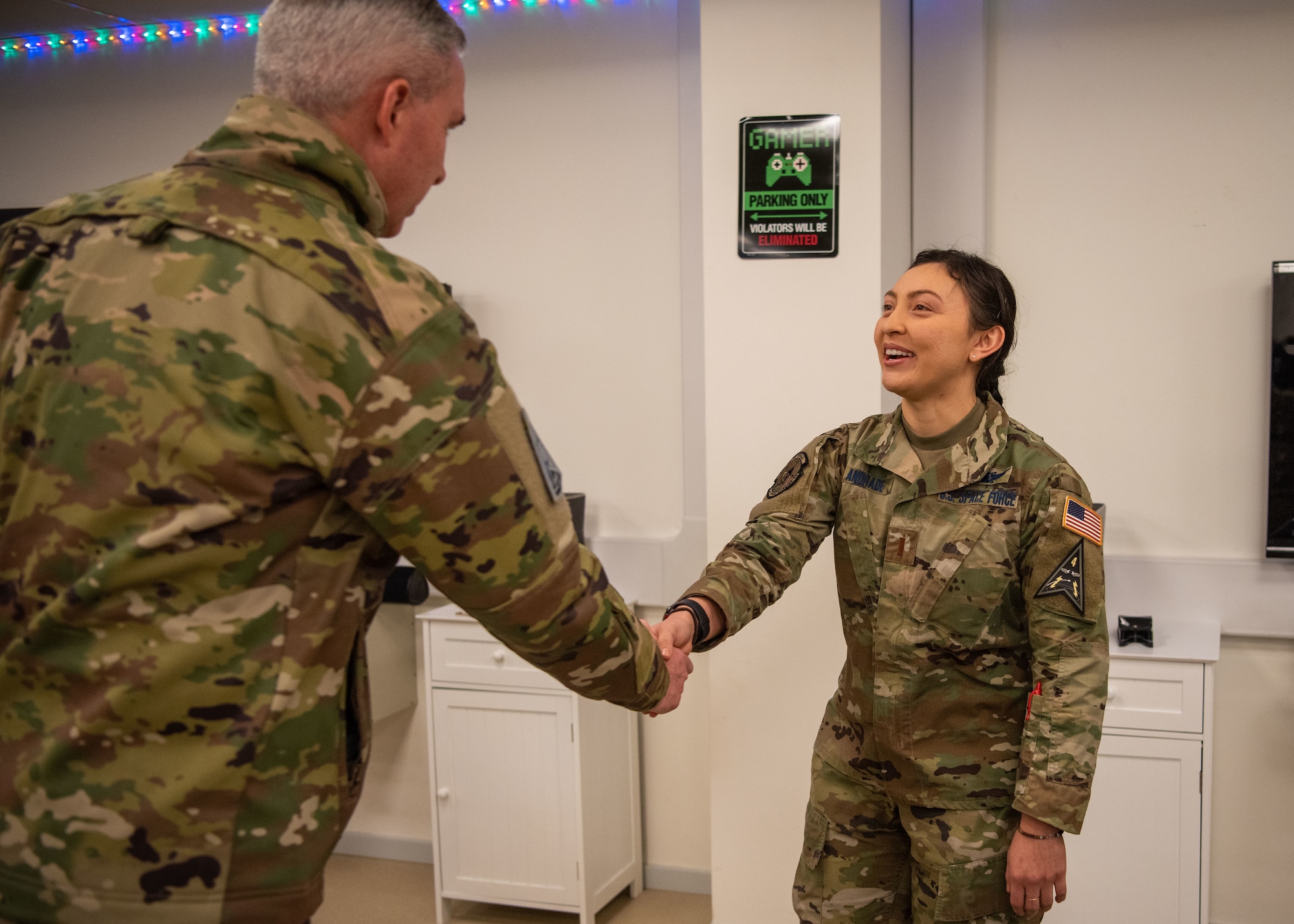 U.S. Space Force 2nd Lt. Shelby Andrade, 12th Space Warning Squadron crew commander, meets Lt. Gen. Stephen N. Whiting, Space Operations Command commander, at the morale Polar Lounge after being recognized for her superior performance while at Thule Air Base, Greenland, Dec. 17, 2021. Gen. Whiting and the SpOC command team traveled to Thule to visit various locations throughout the base to better understand the current challenges Airmen and Guardians are facing in terms of mission and quality of life. Thule is the Department of Defense’s northernmost installation located 750 miles north of the Arctic Circle and only 947 miles south of the North Pole which brings significant challenges such as significant internet degradation, seasonal depression issues, and more. (U.S. Space Force photo by Master Sgt. Sara Keller)