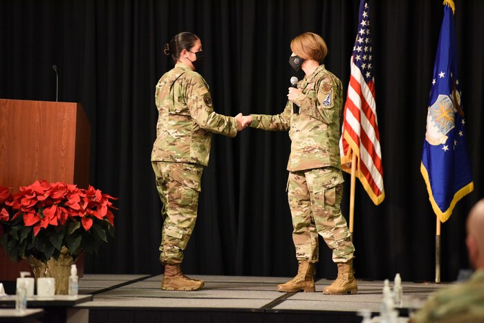 Image of an Airman shaking the hand of another Airman.
