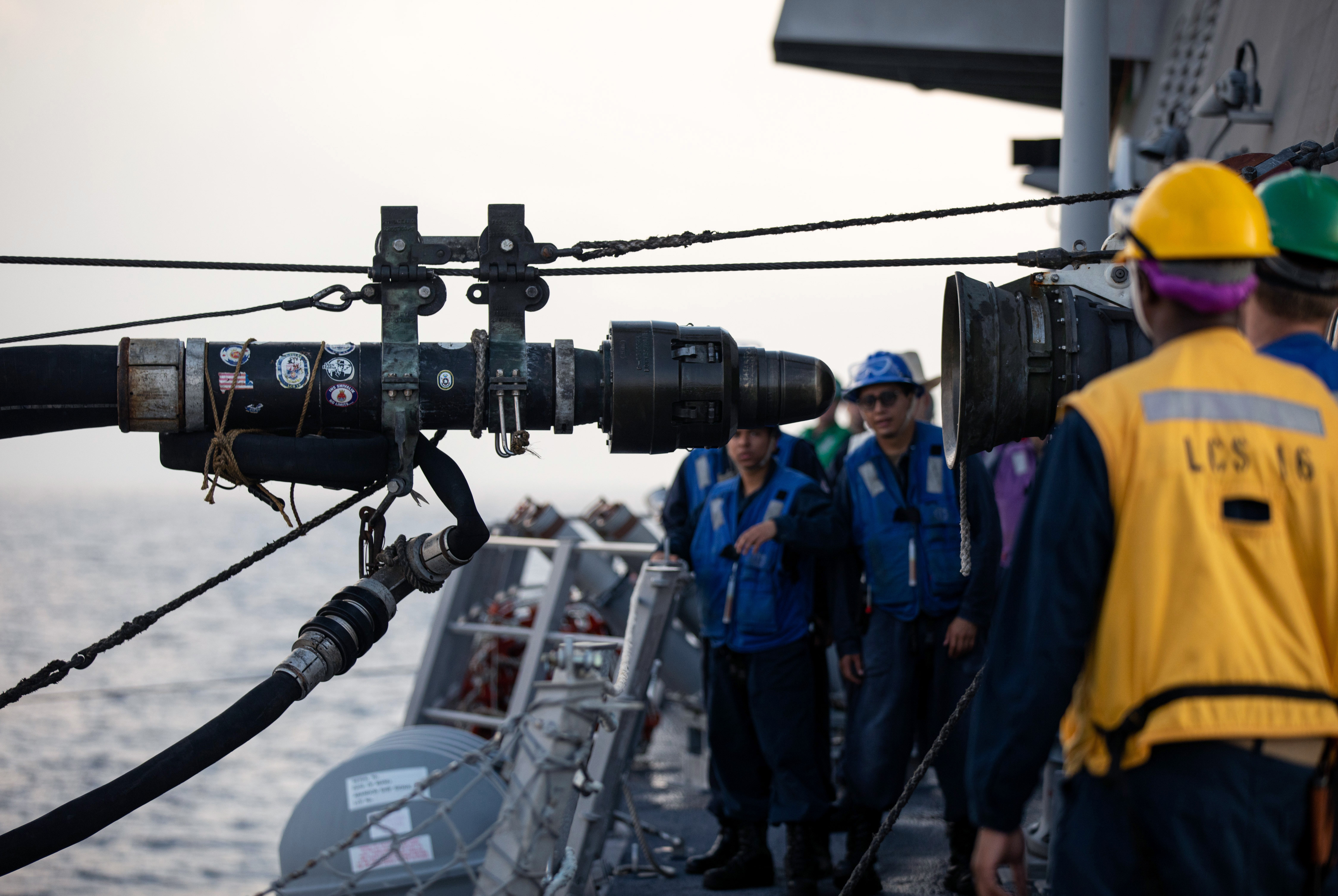 A fuel probe from the fleet replenishment oiler USNS Yukon (T-AO 202) approaches the Independence-variant littoral combat ship USS Tulsa (LCS 16) during a replenishment-at-sea.