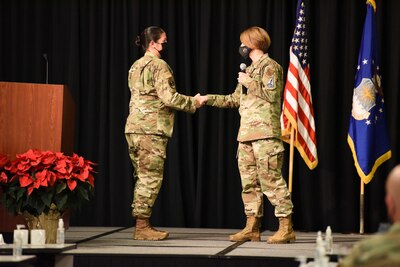 Image of an Airman shaking the hand of another Airman.