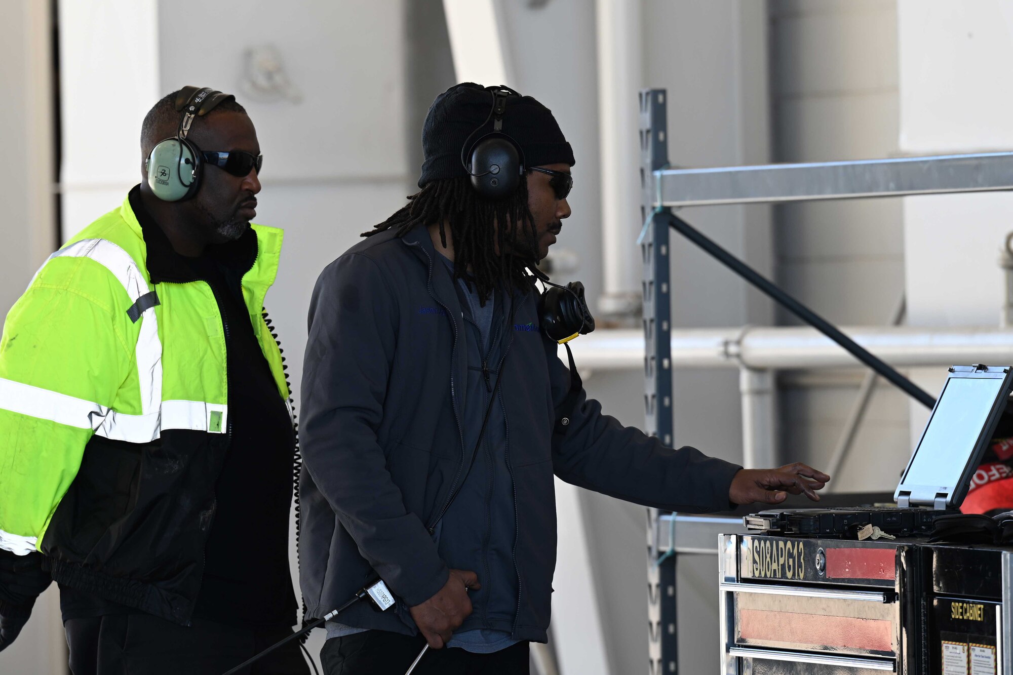 Two civilian contractors, assigned to the 8th Aircraft Maintenance Unit, prepare to conduct pre-flight checks for an F-16 Viper during a transition ceremony, Dec. 22, 2021, on Holloman Air Force Base, New Mexico. The ceremony marks the increase of the 849th Aircraft Maintenance Squadron’s official F-16 inventory by 28 and personnel count by over 200, making the 849th AMXS the 49th Wing’s largest squadron. (U.S. Air Force photo by Staff Sgt. Christopher S. Sparks)