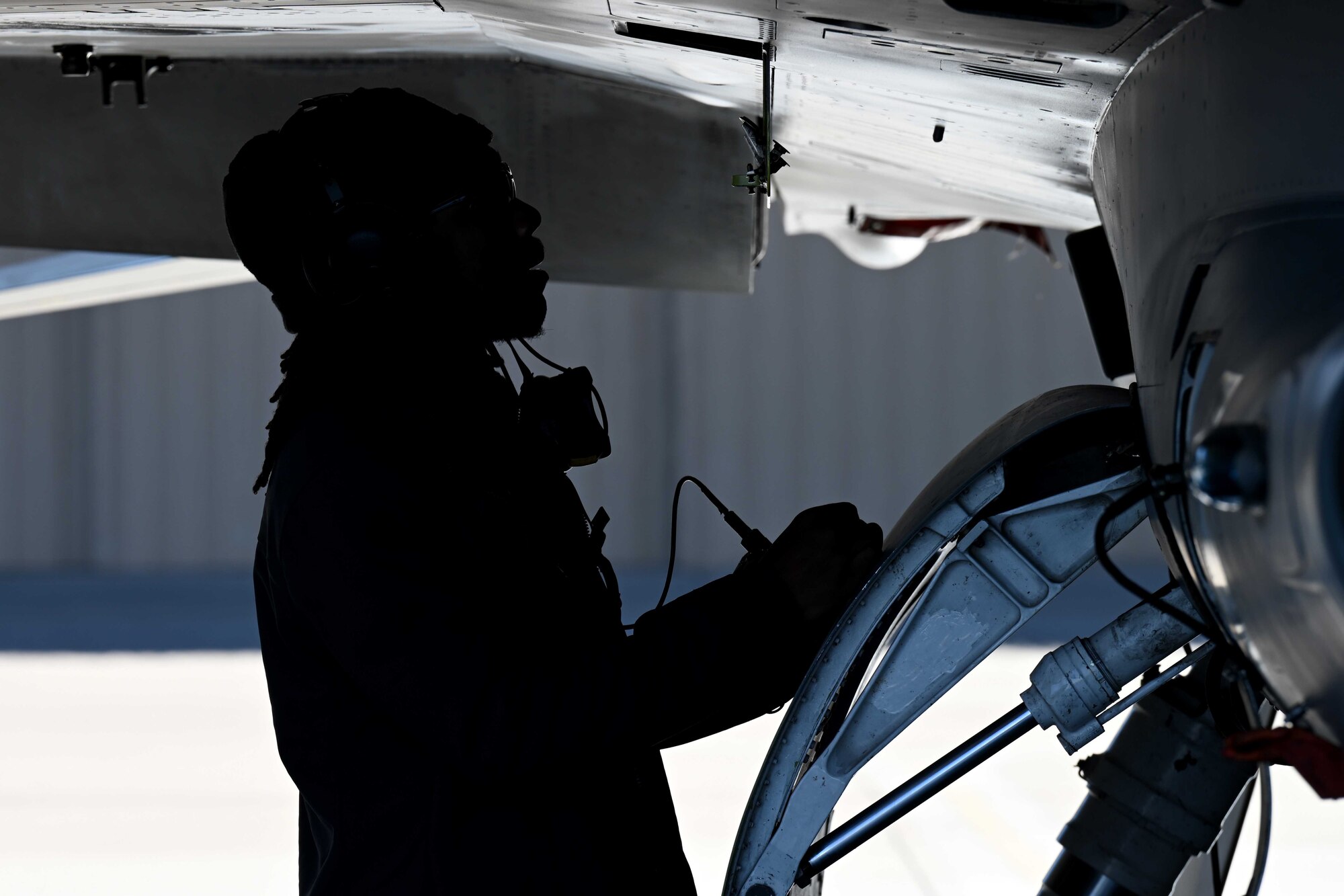 A civilian contractor, assigned to the 8th Aircraft Maintenance Unit, conducts pre-flight checks for an F-16 Viper during a transition ceremony, Dec. 22, 2021, on Holloman Air Force Base, New Mexico. The addition of over 200 positions and 28 aircraft from the 8th AMU makes the 849th Aircraft Maintenance Squadron the largest of its kind in the U.S. Air Force.  (U.S. Air Force photo by Staff Sgt. Christopher S. Sparks)