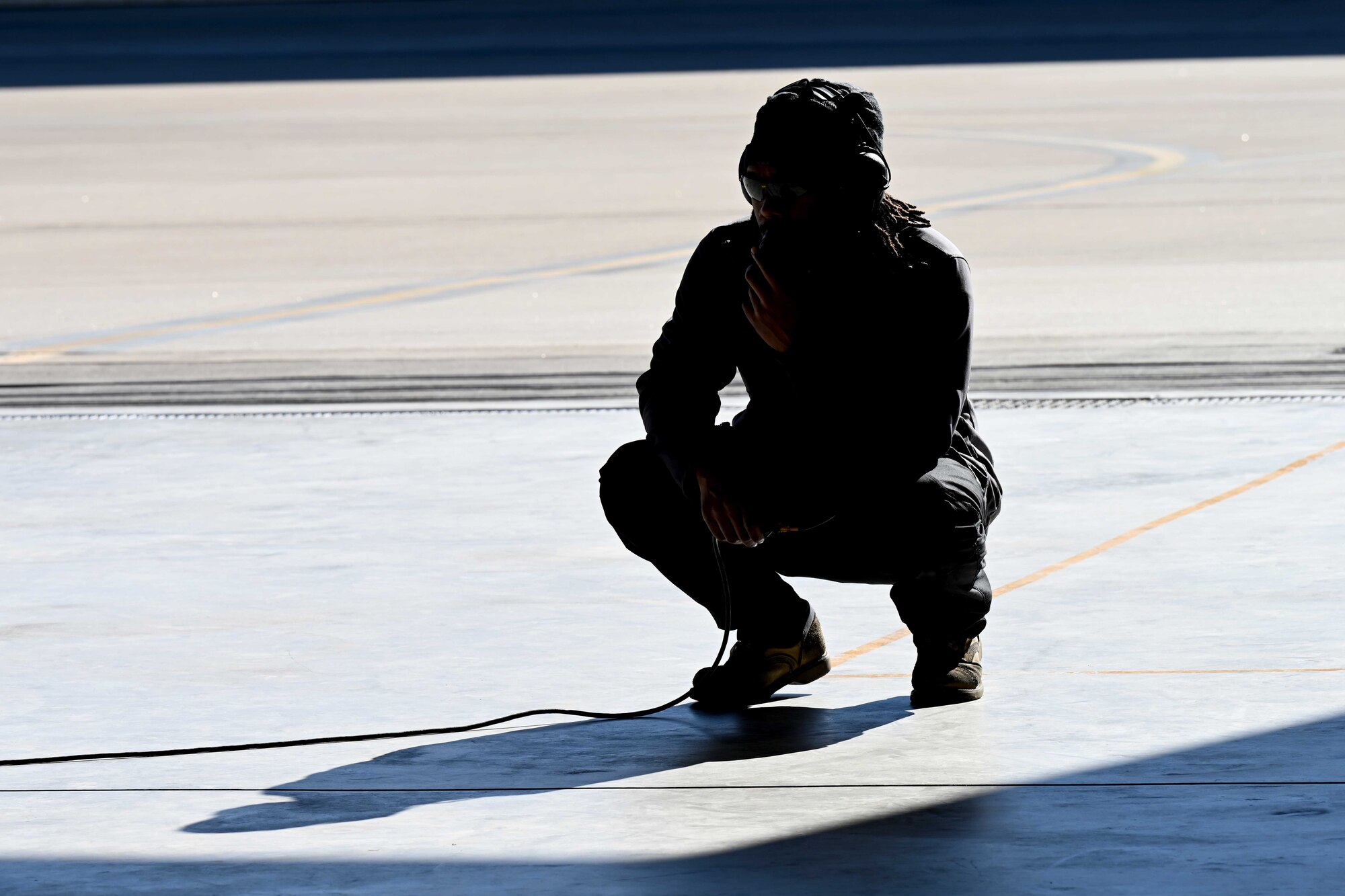 A civilian contractor, assigned to the 8th Aircraft Maintenance Unit, communicates with an F-16 Viper pilot during pre-flight checks during a transition ceremony, Dec. 22, 2021, on Holloman Air Force Base, New Mexico. The ceremony signaled the 8th AMU’s change of responsibility from civilian contractors to enlisted personnel for the management and maintenance of 8th Fighter Squadron aircraft. (U.S. Air Force photo by Staff Sgt. Christopher S. Sparks)