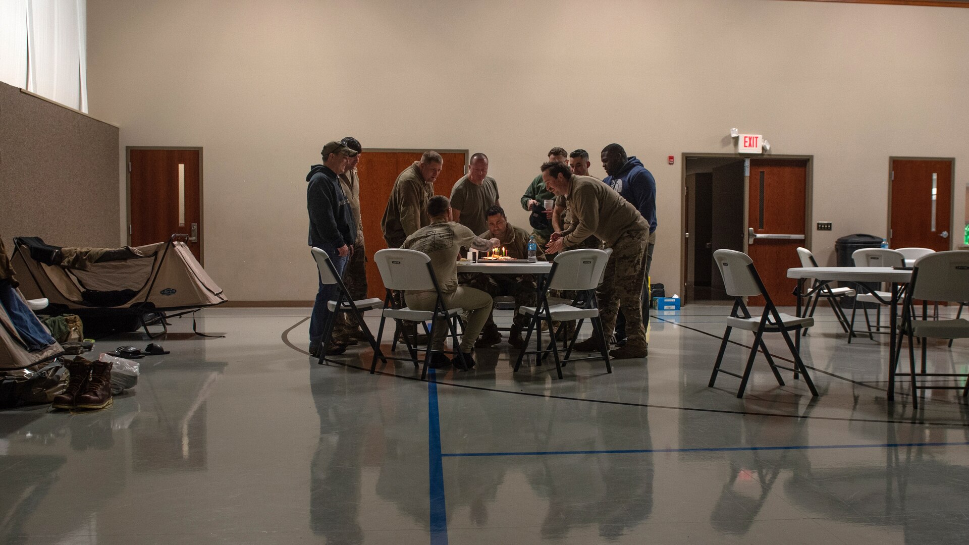 During the morning shift change, members of the Kentucky Air National Guard’s 123rd Security Forces Squadron and 123rd Contingency Response Group celebrate the birthday of Tech. Sgt. Miah Helms in Mayfield, Ky., Dec. 18, 2021. The units rapidly mobilized 17 Airmen from Louisville, Ky., to augment the Mayfield Police Department following a Category 5 tornado that leveled much of the town. (U.S. Air National Guard photo by Staff Sgt. Clayton Wear)