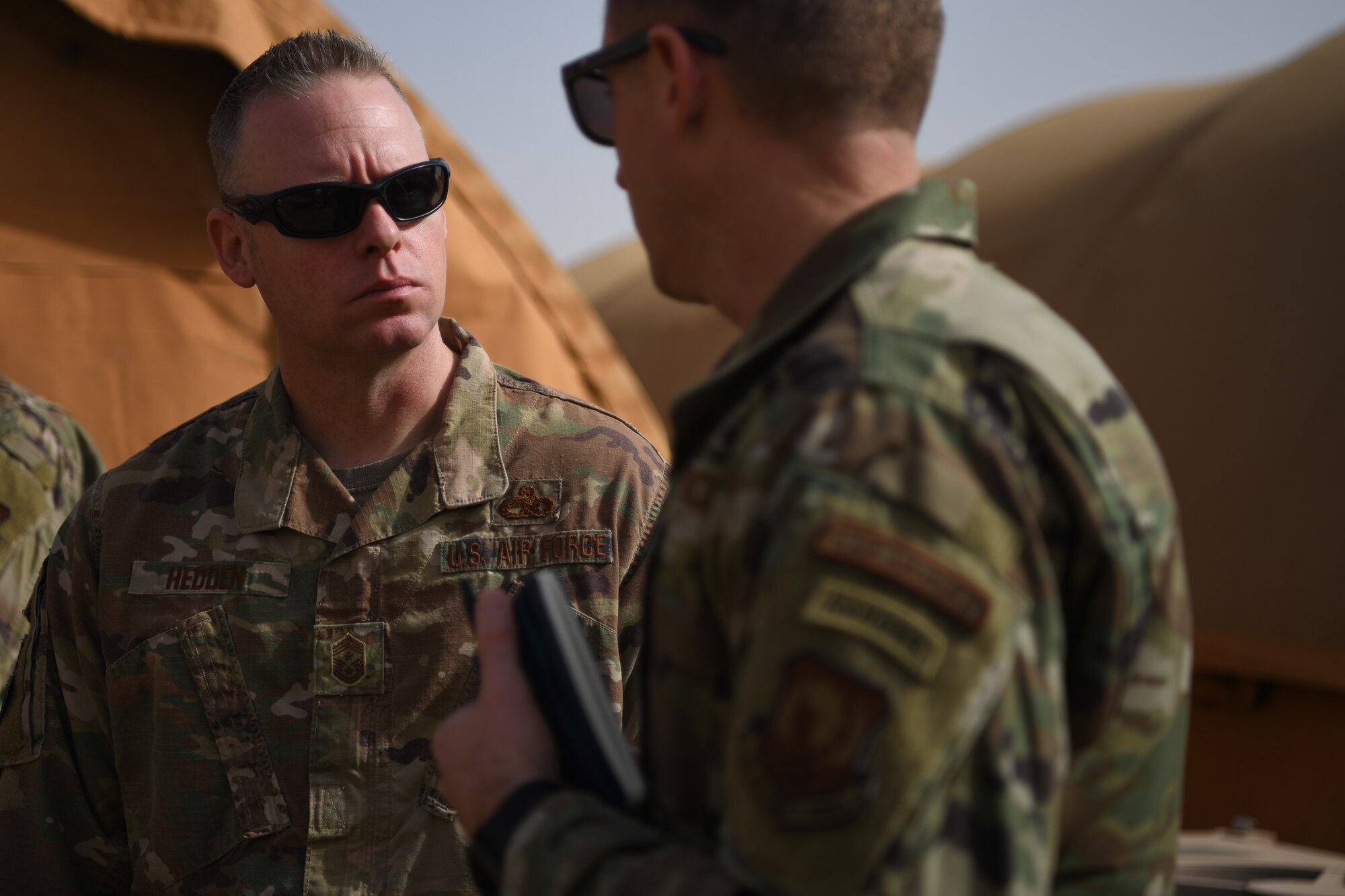 Chief Master Sgt. Benjamin W. Hedden, U.S. Air Forces in Europe and U.S. Air Forces Africa command chief, left, talks to Chief Master Sgt. Corey Crow, 435th Air Ground Operations Wing and 435th Air Expeditionary Wing command chief, at Nigerien Air Base 101, Niamey, Dec. 22, 202. Members from agency headquarters often conduct site visits to downrange personnel to measure team preparedness, capabilities, and receive ground level situational awareness. (U.S. Air Force photo by Senior Airman Ericka A. Woolever)