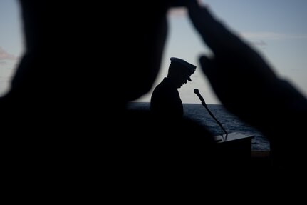 Cmdr.  Matthew Enos, executive officer of Strike Fighter Squadron (VFA) 11, gave a eulogy for his father during a buria at sea aboard the Nimitz-class aircraft carrier USS Harry S. Truman (CVN 75), Dec. 11, 2021.
